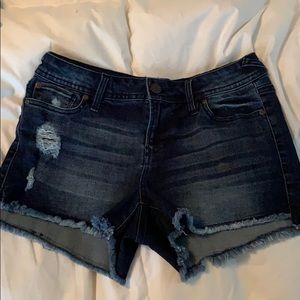 Dark wash, distressed jean shorts.